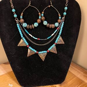 Tribal necklace 3 tier in the front on a dark gold chain with dangle earring 20”